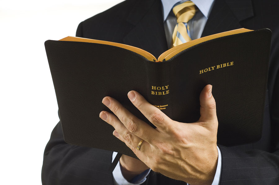 preacher holding bible open