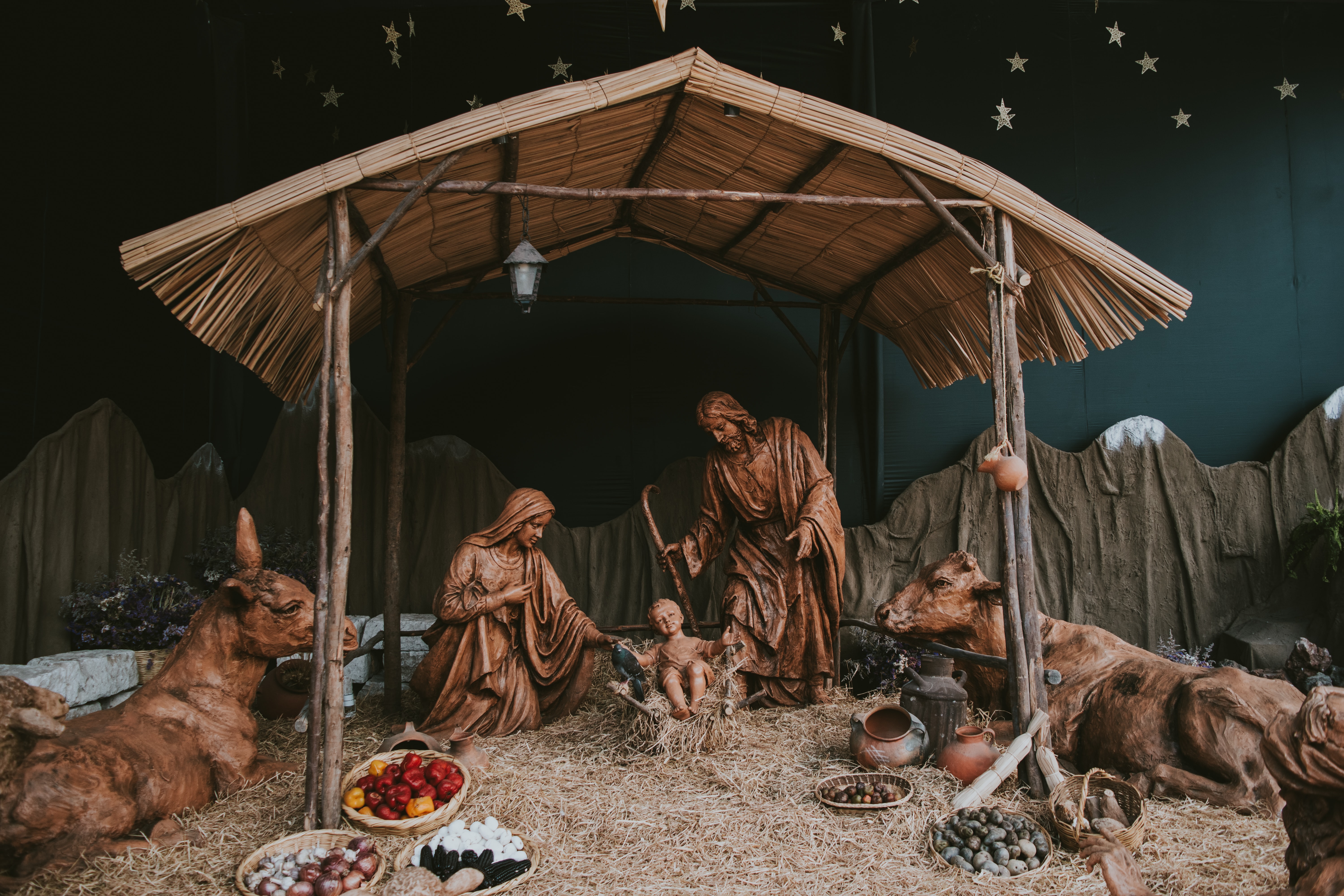 nativity scene, baby jesus in a manger, wooden figurines and animals